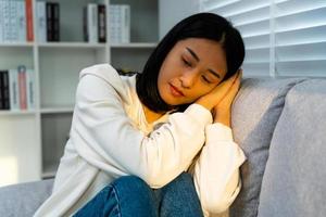 Depression and mental illness. Asian woman disappointed, sad after receiving bad news. Stressed girl confused with unhappy problems, arguing with boyfriend, cry and worry about unexpected pregnancy. photo