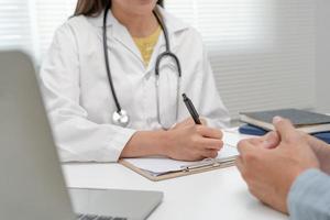 female doctor advice consulting diagnosis and check-up at hospital clinic. Patient explain health problems and symptoms to Professional physician. medical, medicine, treatment, therapy, pharmacy photo