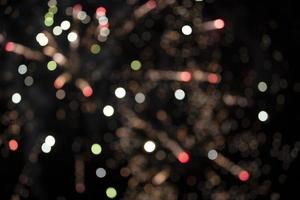 On a black background bokeh from explosions of colorful fireworks. photo