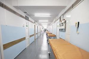 Long hospital corridor with gurneys without people. photo