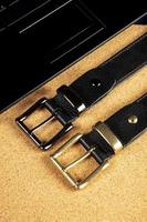 Part of leather belts with metal buckles. photo