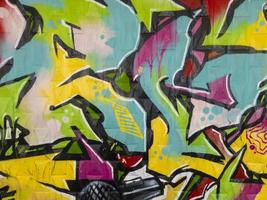 Part of a bright multi-colored wall graffiti. Youth art culture. photo