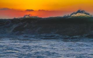 Colorful golden sunset big wave and beach Puerto Escondido Mexico. photo