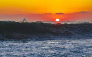 Colorful golden sunset big wave and beach Puerto Escondido Mexico. photo