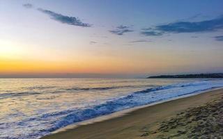 Colorful golden sunset big wave and beach Puerto Escondido Mexico. photo