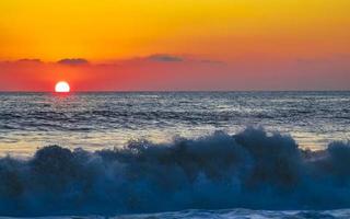 Colorful golden sunset big wave and beach Puerto Escondido Mexico. photo