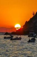 Colorful golden sunset boats wave and beach Puerto Escondido Mexico. photo