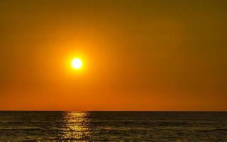 Colorful golden sunset big wave and beach Puerto Escondido Mexico. photo