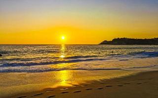 Colorful golden sunset big wave and beach Puerto Escondido Mexico. photo