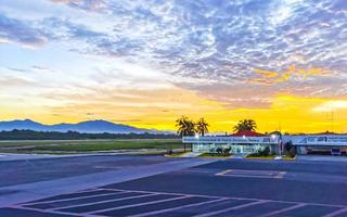 Puerto Escondido Oaxaca Mexico 2022 Colorful sunrise at airport with mountains in Puerto Escondido Mexico. photo