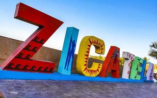 Colorful Zicatela Puerto Escondido lettering sign symbol on beach Mexico. photo