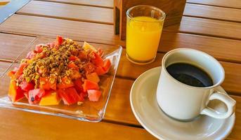 Breakfast at restaurant fruits with oatmeal orange juice and coffee. photo