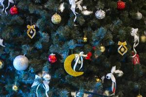 Part of a Christmas tree decorated with colorful toys. photo