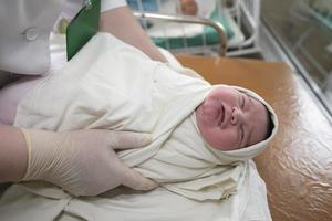 Neonatology. A newborn in a special incubator. medical staff caring for a newborn in the hospital. photo