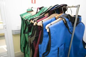 Rack of lead aprons used for x-ray protection in operating room, hospital photo