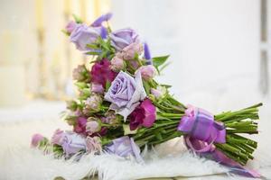 Bouquet of beautiful multi-colored roses on a light background. Floristics. photo