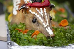 Festive food pig decorated with fruits. photo