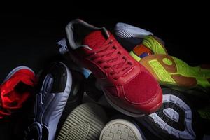 Sport shoes. Various sneakers on a dark background. photo