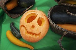 Pumpkin for Halloween on the background of autumn vegetables and fruits. photo