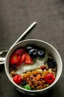 Breakfast oatmeal with fruits and nuts photo