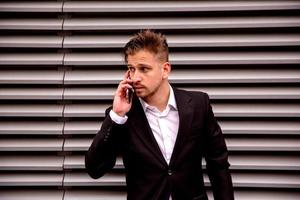 Portrait of a young businessman talking on the phone photo