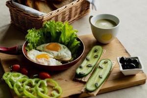 classic breakfast, scrambled eggs, simit bun, fresh vegetables, cucumber photo