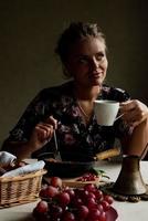 Girl having breakfast in the kitchen early in the morning photo