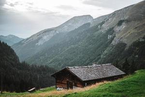 Wooden hut in the alps with mountains in the background Panorama photo