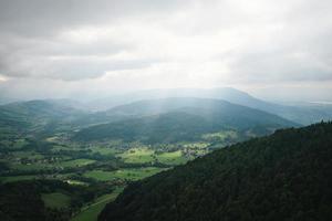 Majestic mountains in the Alps covered with trees and clouds photo