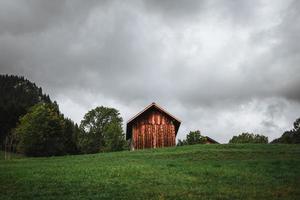 Wooden hut in the alps with mountains in the background Panorama photo