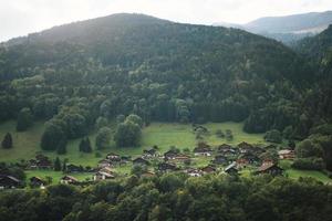 Majestic mountains in the Alps covered with trees and clouds photo