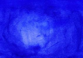 Watercolor dark blue background with space for text. Stains on paper photo