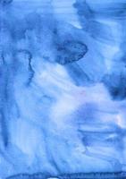 Watercolor liquid blue background texture. Hand painted watercolour backdrop. Sky blue stains on paper. photo