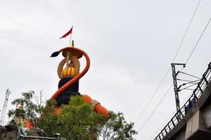 New Delhi, India - June 21, 2022 - Big statue of Lord Hanuman near the delhi metro bridge situated near Karol Bagh, Delhi, India, Lord Hanuman big statue touching sky photo