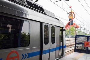 New Delhi India - June 21 2022 - Delhi Metro train arriving at Jhandewalan metro station in New Delhi, India, Asia, Public Metro departing from Jhandewalan station photo