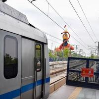 New Delhi India - June 21 2022 - Delhi Metro train arriving at Jhandewalan metro station in New Delhi, India, Asia, Public Metro departing from Jhandewalan station photo