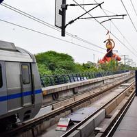 New Delhi India - June 21 2022 - Delhi Metro train arriving at Jhandewalan metro station in New Delhi, India, Asia, Public Metro departing from Jhandewalan station photo