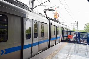 nueva delhi india - 21 de junio de 2022 - tren del metro de delhi que llega a la estación de metro de jhandewalan en nueva delhi, india, asia, metro público que sale de la estación de jhandewalan foto