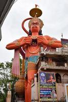 New Delhi, India - June 21, 2022 - Big statue of Lord Hanuman near the delhi metro bridge situated near Karol Bagh, Delhi, India, Lord Hanuman big statue touching sky photo