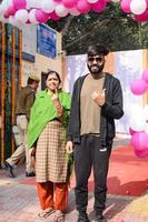 New Delhi, India - December 04 2022 - Unidentified people showing their ink-marked fingers after casting votes in front of polling booth of east Delhi area for MCD local body Elections 2022 photo