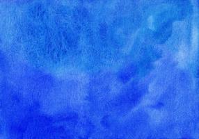 Watercolor deep blue background texture hand painted. Aquarelle azure blue abstract backdrop. Stains on paper photo