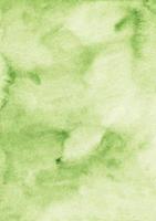 Watercolor light green background texture. Aquarelle greenery color backdrop. Stains on paper photo