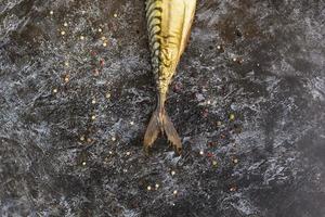 Smoked mackerel without head on black background. copyspace top view photo