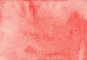 Watercolor coral background texture. Artistic light red backdrop. Stains on paper photo
