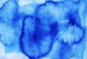 Watercolor deep blue liquid background. Stains on paper. photo