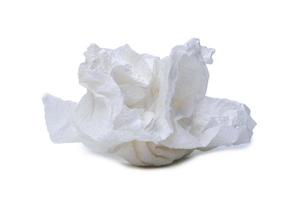 Single screwed or crumpled tissue paper or napkin in strange shape after use in toilet or restroom isolated on white background with clipping path photo