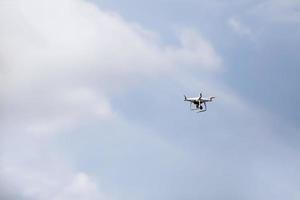 Quadcopter drone in sky. Small drone flies in sky taking video and photos. Remote control air delivery and spy. selective focus. photo