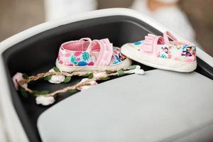 Cute floral baby girl shoes. Stylish baby shoes and baby hair decoration in flowers. Childhood. selective focus photo