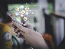 Concept with notification icons of like being happyand social media interactions on mobile phone,message, email, comment ,businessman hands holding device photo