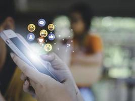 Concept with notification icons of like being happyand social media interactions on mobile phone,message, email, comment ,businessman hands holding device photo
